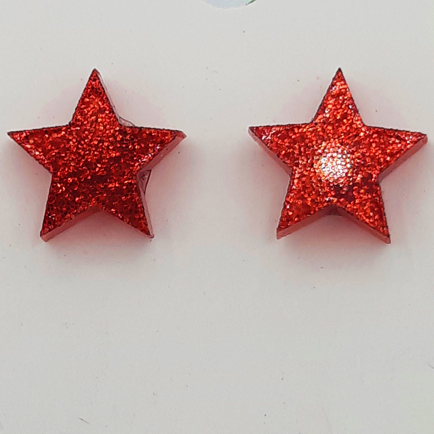 Star laser cut acrylic earrings - red glitter